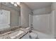 Bathroom featuring granite countertop, white cabinets and shower-tub combination at 4421 Fulson Dr, Lilburn, GA 30047
