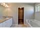 Bathroom features a soaking tub, tile floors, and a granite countertop on the vanity at 4421 Fulson Dr, Lilburn, GA 30047