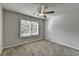 Bedroom features neutral paint, carpeted floors, and a window letting in light at 4421 Fulson Dr, Lilburn, GA 30047