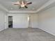 A spacious bedroom with neutral walls, gray carpet, a ceiling fan, and recessed lighting at 4421 Fulson Dr, Lilburn, GA 30047