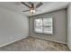 Carpeted bedroom with ceiling fan and natural light streaming in through a window at 4421 Fulson Dr, Lilburn, GA 30047