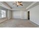 Spacious bedroom features neutral walls, carpet, trey ceiling, and ceiling fan with natural light at 4421 Fulson Dr, Lilburn, GA 30047