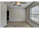Bedroom features neutral paint, carpeted floors, and a window letting in light at 4421 Fulson Dr, Lilburn, GA 30047