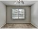 Bedroom featuring neutral walls, ceiling fan, and a window letting in natural light at 4421 Fulson Dr, Lilburn, GA 30047