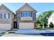 Charming townhome featuring a brick facade, attached garage, and well-maintained landscaping at 4421 Fulson Dr, Lilburn, GA 30047