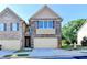 Charming townhome featuring a brick facade, attached garage, and well-maintained landscaping on a sunny day at 4421 Fulson Dr, Lilburn, GA 30047