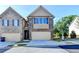 Charming townhome featuring a brick facade, attached garage, and well-maintained landscaping at 4421 Fulson Dr, Lilburn, GA 30047