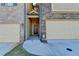 Inviting front entrance with a covered porch, sidelights, and an attached garage, offering curb appeal at 4421 Fulson Dr, Lilburn, GA 30047
