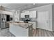 Modern kitchen featuring granite countertops, stainless steel appliances, island, and stylish backsplash at 4421 Fulson Dr, Lilburn, GA 30047