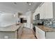Modern kitchen featuring granite countertops, stainless steel appliances, an island, and backsplash at 4421 Fulson Dr, Lilburn, GA 30047