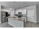 Modern kitchen featuring granite countertops, stainless steel appliances, an island, and stylish backsplash at 4421 Fulson Dr, Lilburn, GA 30047