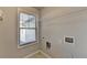 Laundry room featuring tile floor, window, and a wire rack shelf at 4421 Fulson Dr, Lilburn, GA 30047