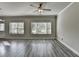 Bright living room with large windows and wood-look flooring at 4421 Fulson Dr, Lilburn, GA 30047