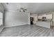 Bright, open living space with modern gray floors and stainless steel kitchen appliances at 4421 Fulson Dr, Lilburn, GA 30047