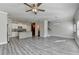 Open floor plan with kitchen and living room area with wood-look floors and stairs at 4421 Fulson Dr, Lilburn, GA 30047