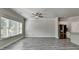 Bright, open living space with modern gray floors, ceiling fan, and large windows at 4421 Fulson Dr, Lilburn, GA 30047