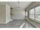 Entry room featuring gray wood floors, a staircase, a door to the outside, and modern light fixture at 4421 Fulson Dr, Lilburn, GA 30047
