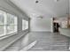Bright, open living space with modern gray floors and stainless steel kitchen appliances at 4421 Fulson Dr, Lilburn, GA 30047