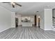Open floor plan with kitchen, living room, wood-look floors and stairs at 4421 Fulson Dr, Lilburn, GA 30047