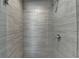 Shower stall tiled with gray stone and a glass partition at 4421 Fulson Dr, Lilburn, GA 30047