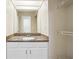 Bathroom featuring a granite countertop, vanity, mirror and white storage shelves for toiletries at 6223 Marbut Farms Ln, Lithonia, GA 30058