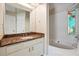 Bathroom featuring granite countertops, white tiling, white cabinetry, and decorative colorful stained glass window at 6223 Marbut Farms Ln, Lithonia, GA 30058