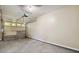 View of an empty garage with concrete floor, white walls, and a partially open garage door at 6223 Marbut Farms Ln, Lithonia, GA 30058