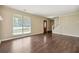Bright living room featuring hardwood floors, a staircase, and a decorative front door at 6223 Marbut Farms Ln, Lithonia, GA 30058