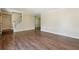Bright living room featuring hardwood floors, a staircase, and built-in shelves at 6223 Marbut Farms Ln, Lithonia, GA 30058