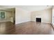 Bright living room featuring hardwood floors, a fireplace, and an open-concept layout at 6223 Marbut Farms Ln, Lithonia, GA 30058