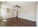 Main bedroom featuring hard wood floors, ceiling fan, natural light, and an interior door at 6223 Marbut Farms Ln, Lithonia, GA 30058