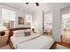 Sunlit bedroom featuring hardwood floors, classic windows, and access to an ensuite bathroom at 653 N Highland Ne Ave # 5, Atlanta, GA 30306