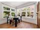 Bright dining area with a glass table, modern chairs, and large windows overlooking the street at 653 N Highland Ne Ave # 5, Atlanta, GA 30306