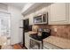 Cozy kitchen featuring granite countertops, stainless steel appliances and white cabinetry at 653 N Highland Ne Ave # 5, Atlanta, GA 30306