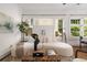 Cozy living room featuring white sofa, woven coffee table, and an abundance of light at 653 N Highland Ne Ave # 5, Atlanta, GA 30306