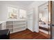 Versatile office area featuring integrated shelving, hardwood floors and convenient bedroom access at 653 N Highland Ne Ave # 5, Atlanta, GA 30306