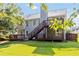 Expansive backyard featuring a deck, large trees, and lush lawn at 7186 Raintree Loop, Jonesboro, GA 30236