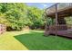 Large backyard with a wooden deck, mature trees, and a well-maintained lawn at 7186 Raintree Loop, Jonesboro, GA 30236