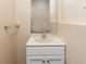 Traditional half bath with white vanity and large neutral sink is perfect for guests at 7186 Raintree Loop, Jonesboro, GA 30236