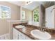 Bathroom featuring a double vanity, large mirror, and abundant natural light at 7186 Raintree Loop, Jonesboro, GA 30236