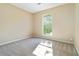 Bedroom features large window with outside view and neutral carpet at 7186 Raintree Loop, Jonesboro, GA 30236