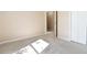 Bedroom featuring neutral walls and carpet, with a closet and doorway leading to another room at 7186 Raintree Loop, Jonesboro, GA 30236