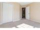 Bedroom featuring double door closet, carpeted floors, and white trim at 7186 Raintree Loop, Jonesboro, GA 30236