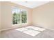 Bright bedroom featuring a large window with a view of lush greenery at 7186 Raintree Loop, Jonesboro, GA 30236