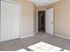 Bedroom featuring neutral walls and carpet, with a closet and doorway leading to another room at 7186 Raintree Loop, Jonesboro, GA 30236