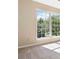 Sunlit bedroom featuring neutral walls and carpet, complemented by a large window offering a serene outdoor view at 7186 Raintree Loop, Jonesboro, GA 30236