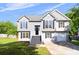 Attractive two-story home with gray siding, black shutters, a well-kept lawn, and an attached one-car garage at 7186 Raintree Loop, Jonesboro, GA 30236
