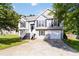 Charming two-story home featuring a well-maintained lawn, garage, and classic architectural details at 7186 Raintree Loop, Jonesboro, GA 30236
