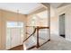 Inviting foyer with staircase, carpeted floors, and natural light streaming through the windows at 7186 Raintree Loop, Jonesboro, GA 30236