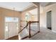 Bright foyer featuring a staircase, pendant light, closet, and doorway leading to other rooms at 7186 Raintree Loop, Jonesboro, GA 30236